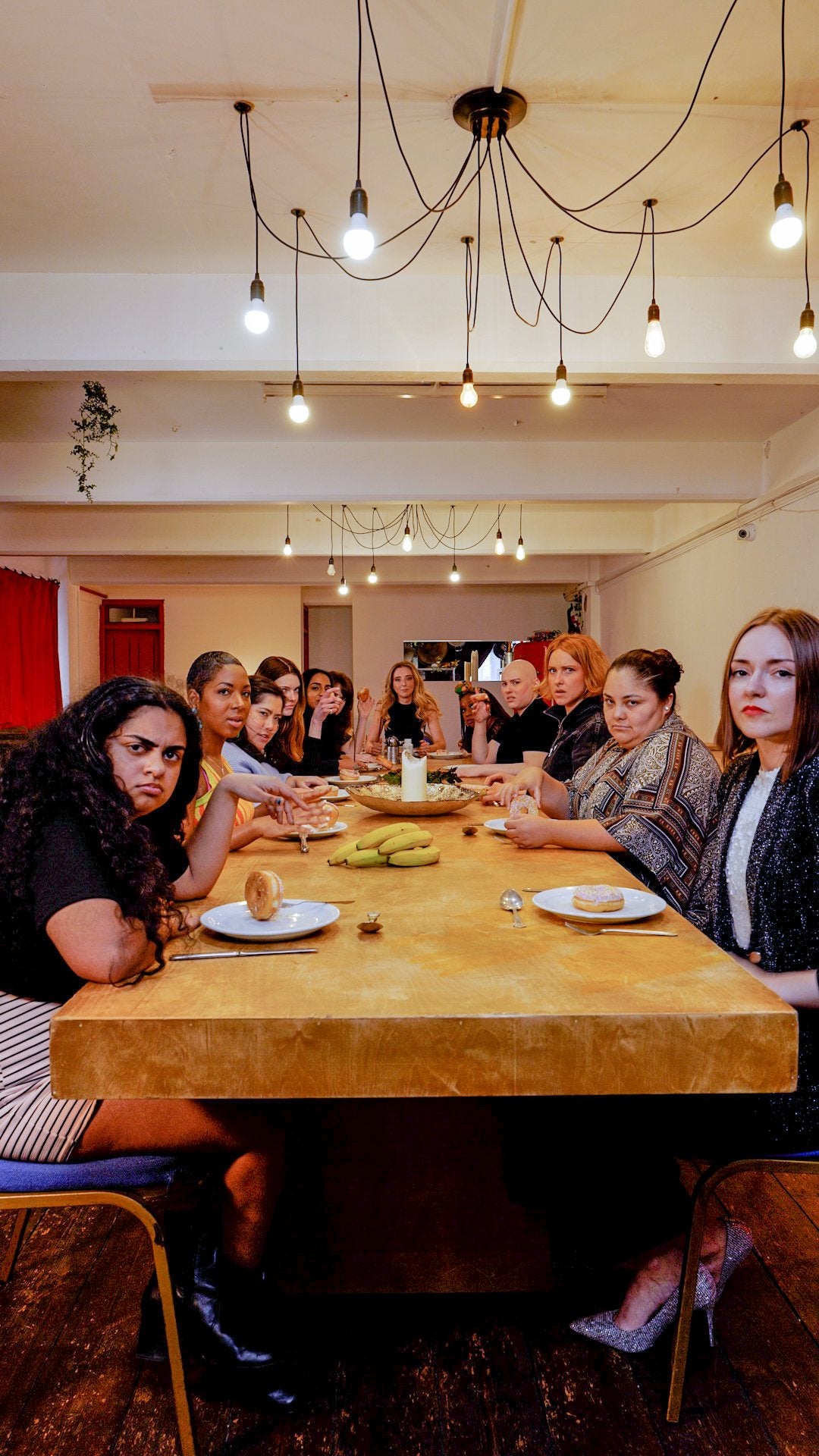 Everyone gathered around a long wooden dinner table